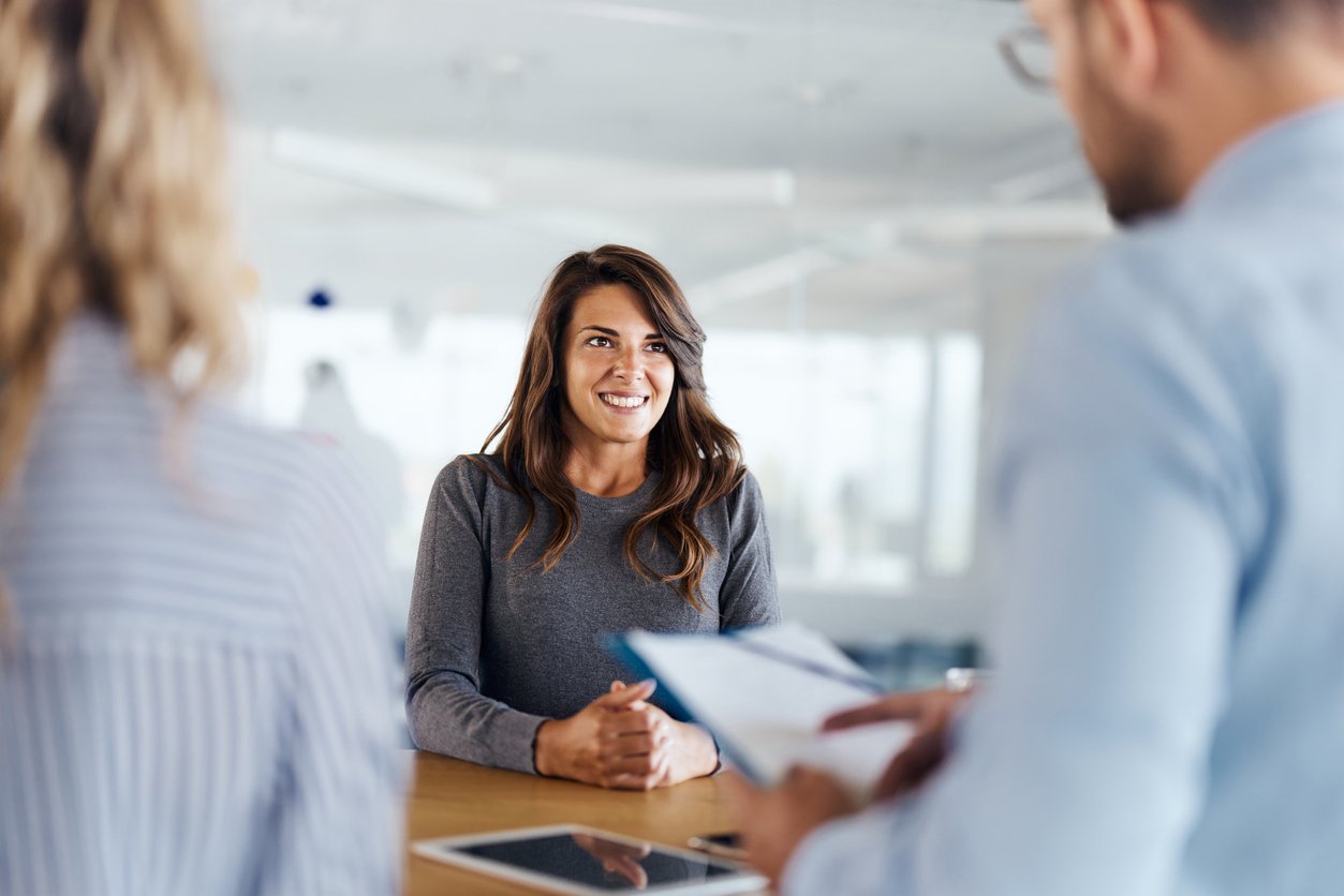 A female job applicant being asked about retail interview questions by two hiring managers