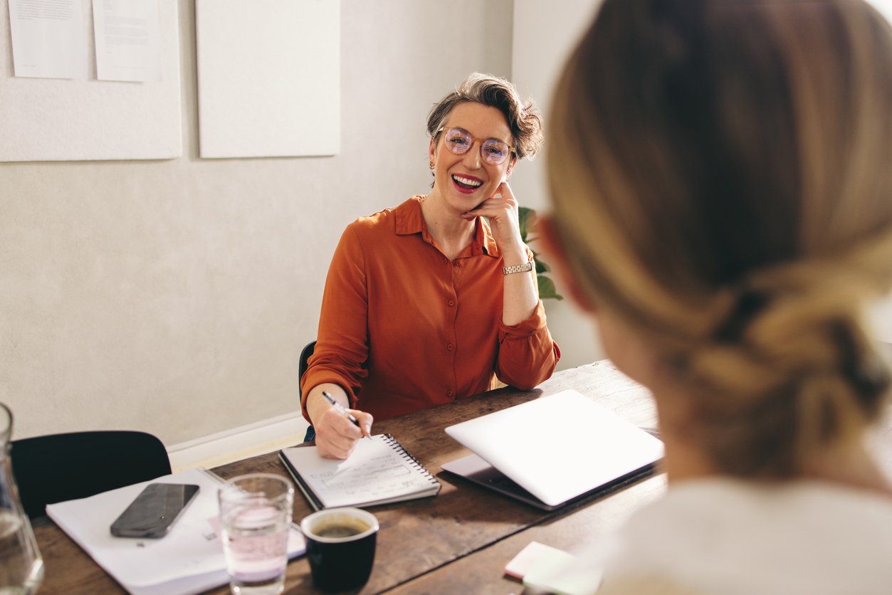 A female retail manager speaking with a female job candidate during an interview