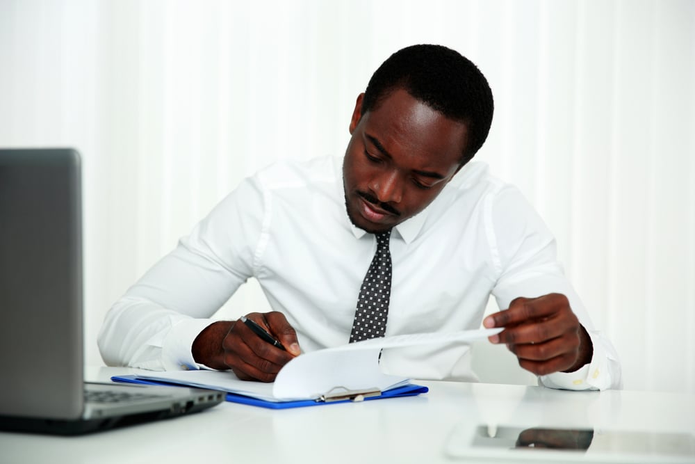 African man signing document in office-1