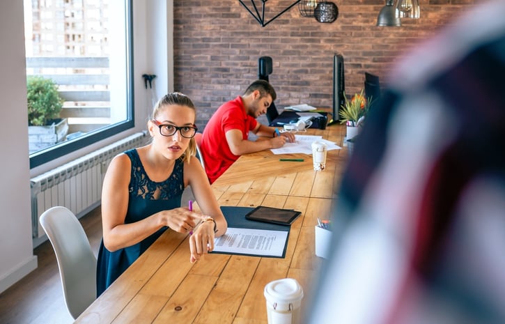 female manager discussing with man for coming late to office