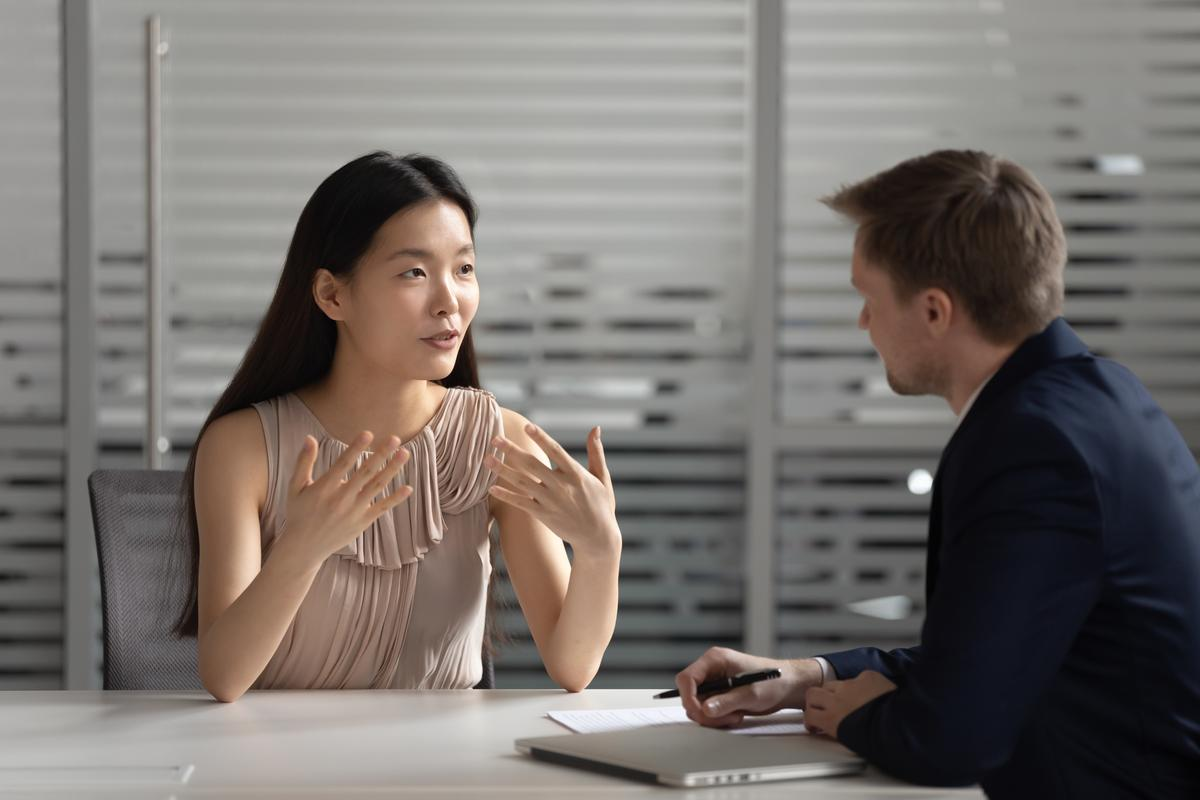 Asian female boss having a meeting with employee