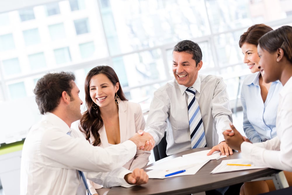 Business handshake in the middle of a meeting at the office-1