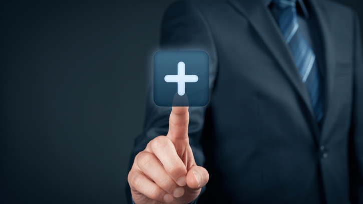 Business man clicking on plus button on a screen symbolising voluntary benefits at work