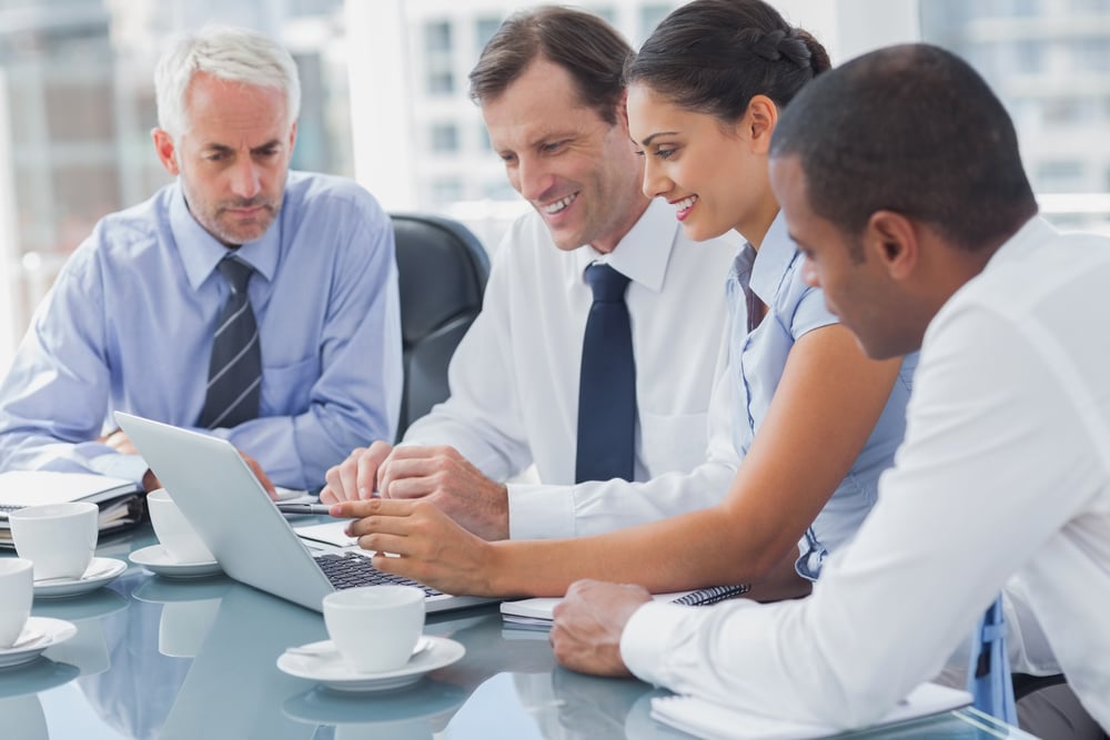 Business people looking at a laptop during a meeting-1