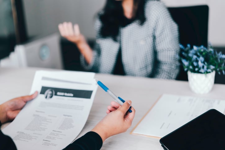 manager looking at candidate resume during lateral hiring process