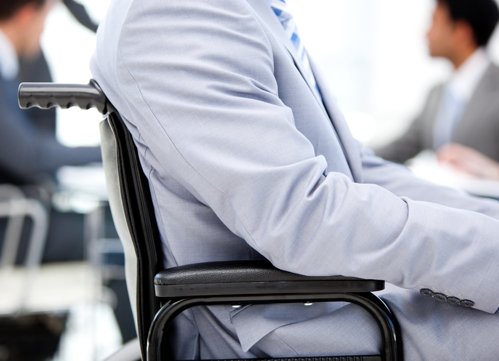 Close-up of a businessman sitting on a wheelchair in a meeting-1