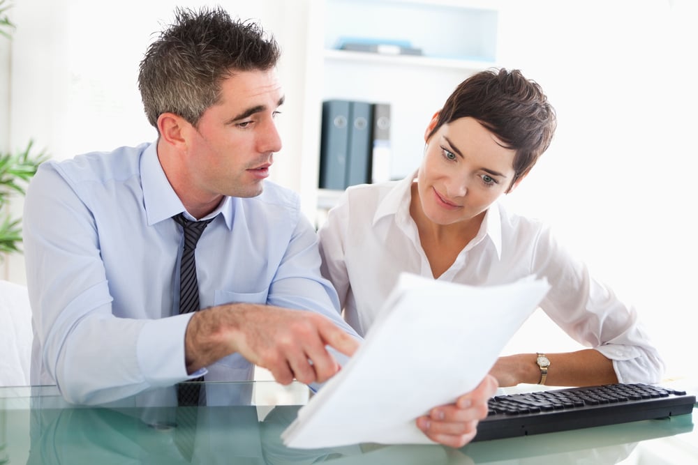 Colleagues reading documents in an office-1