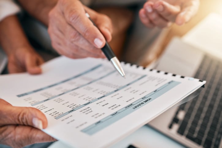 Documents, couple hands and budget for home financial planning, accounting and numbers review.