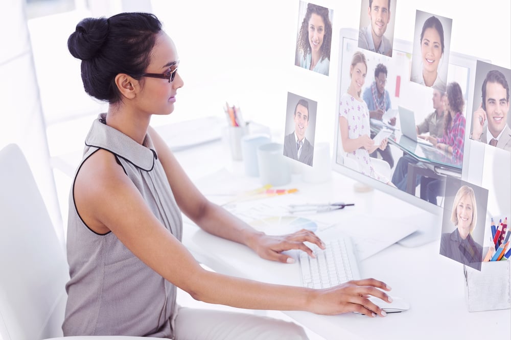 Editor holding tablet and smiling as team works behind her against profile pictures-1