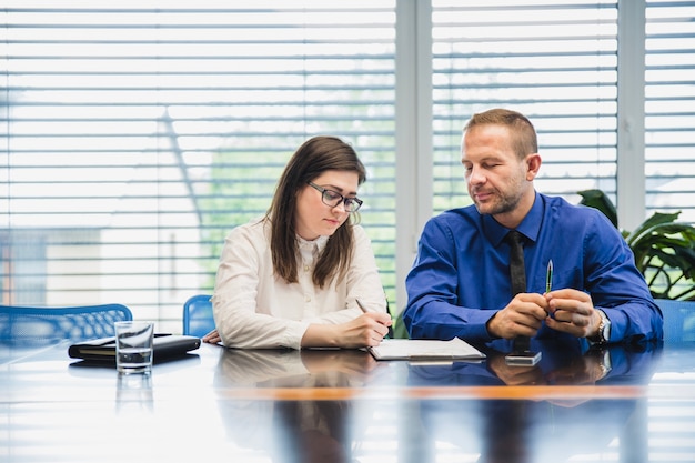 Team of employees discussing wage drift strategies in an office setting.