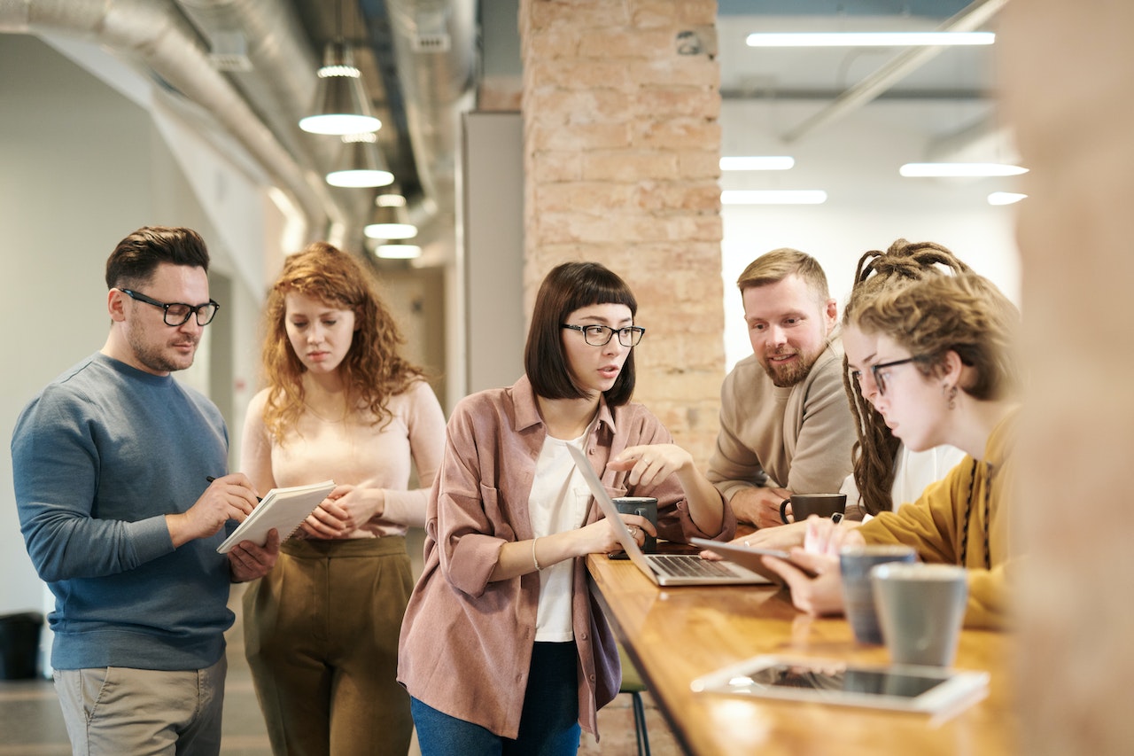 Employees standing in the hall discussing work project