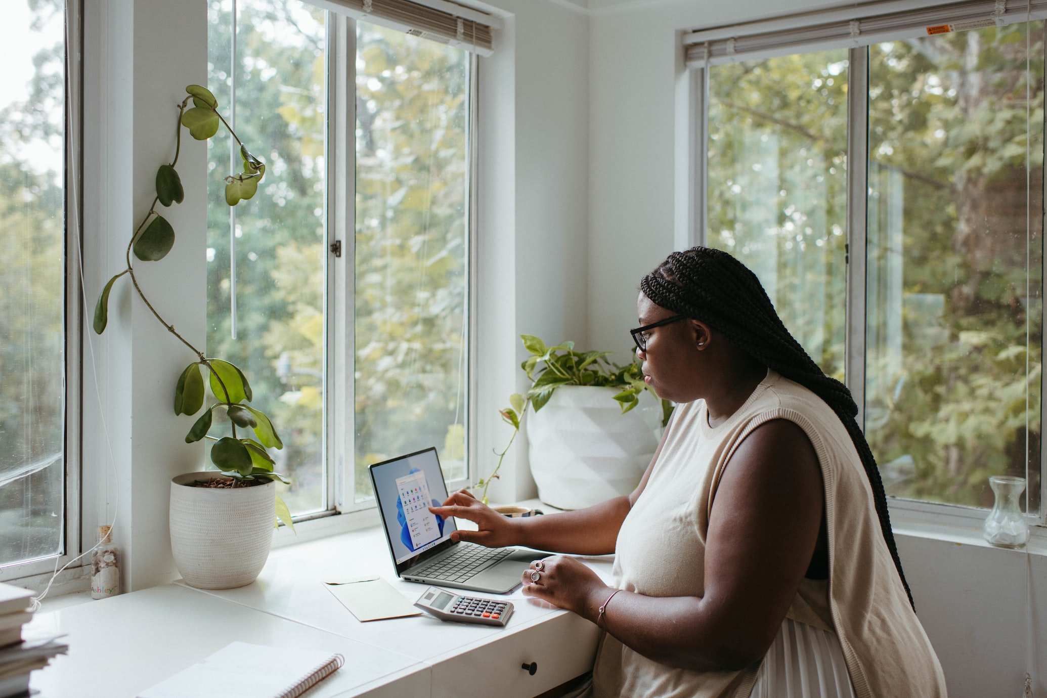 Female African American woman working from home on laptop