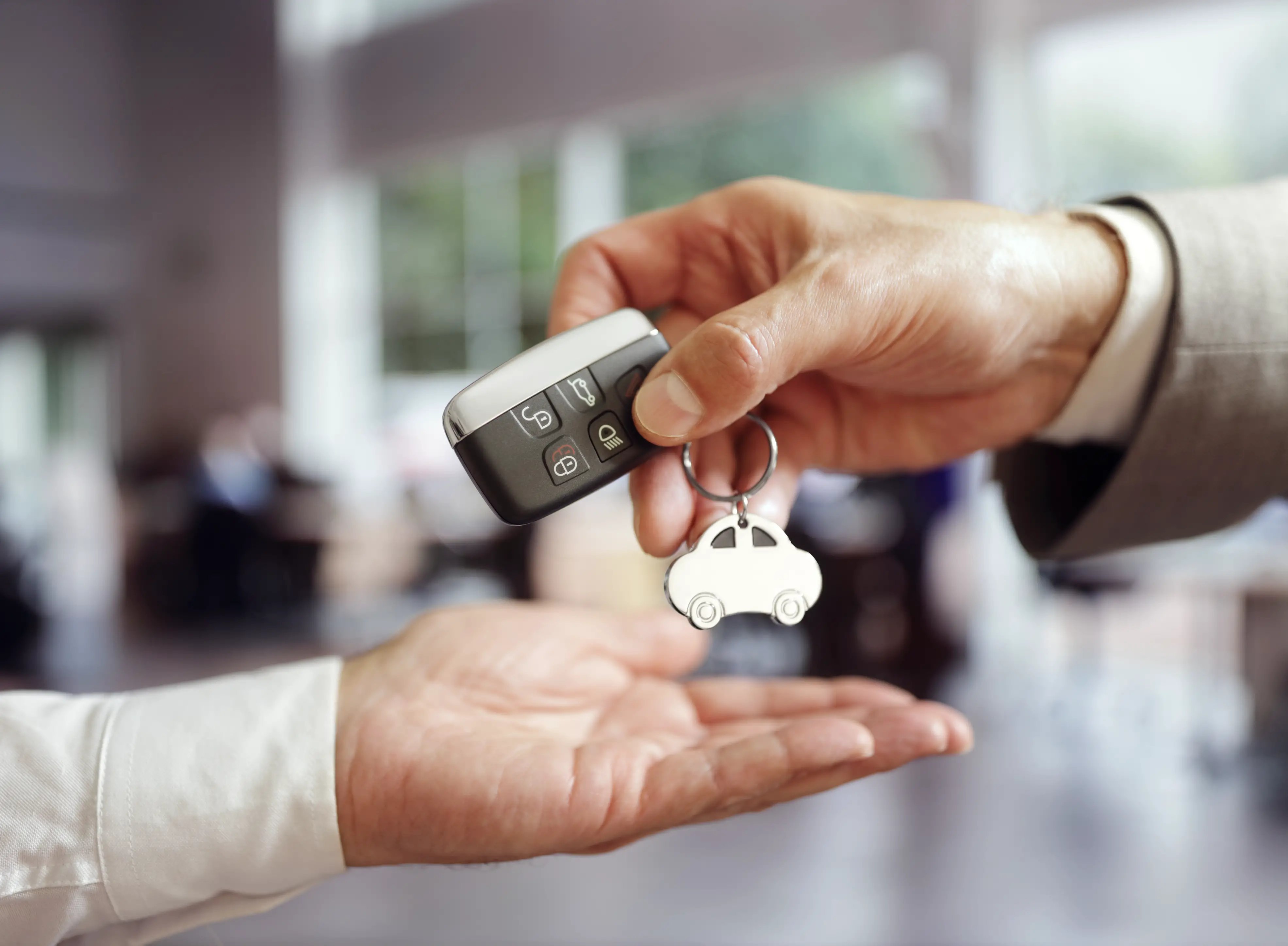 Handing keys of new company car to employee