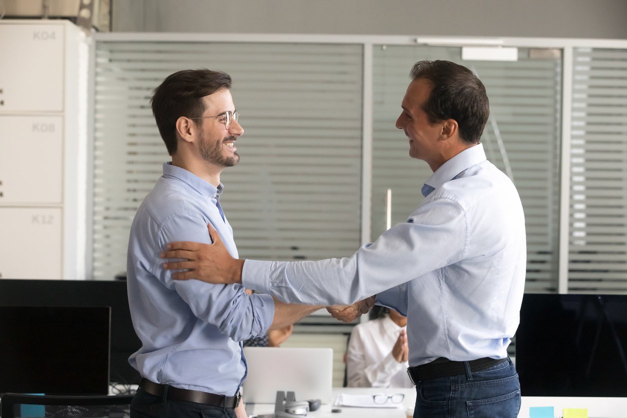 Happy Manager and employee shaking hand, employee recognised or congratulated on promotion