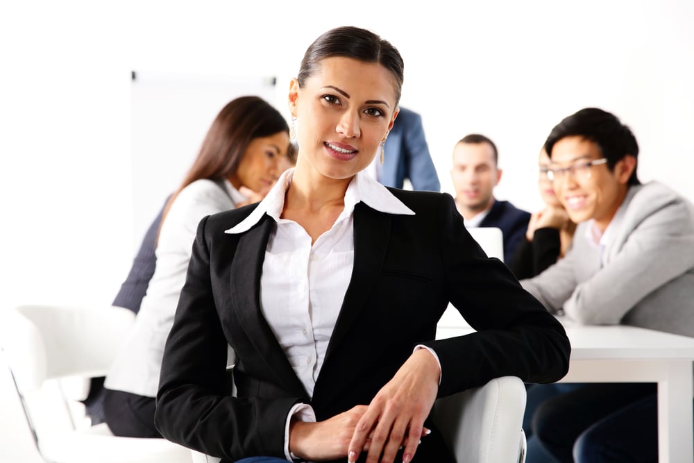 Happy businesswoman sitting in front of business meeting