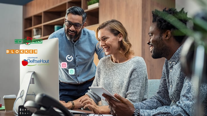 Happy employers using employee scheduling software on laptop