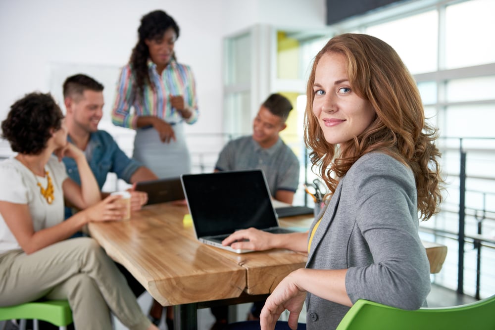 Image of a succesful casual business woman using laptop during meeting-3