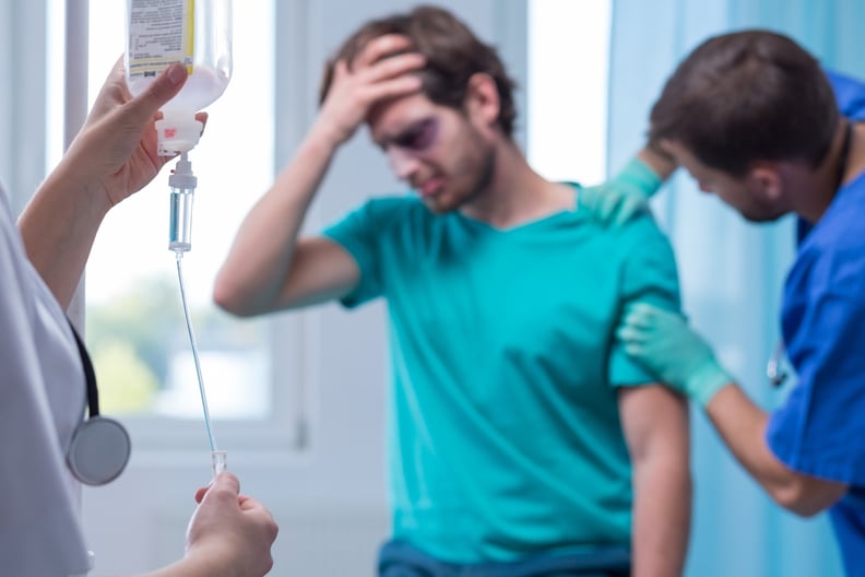 Image of nurse preparing intravenous drip for injured patient