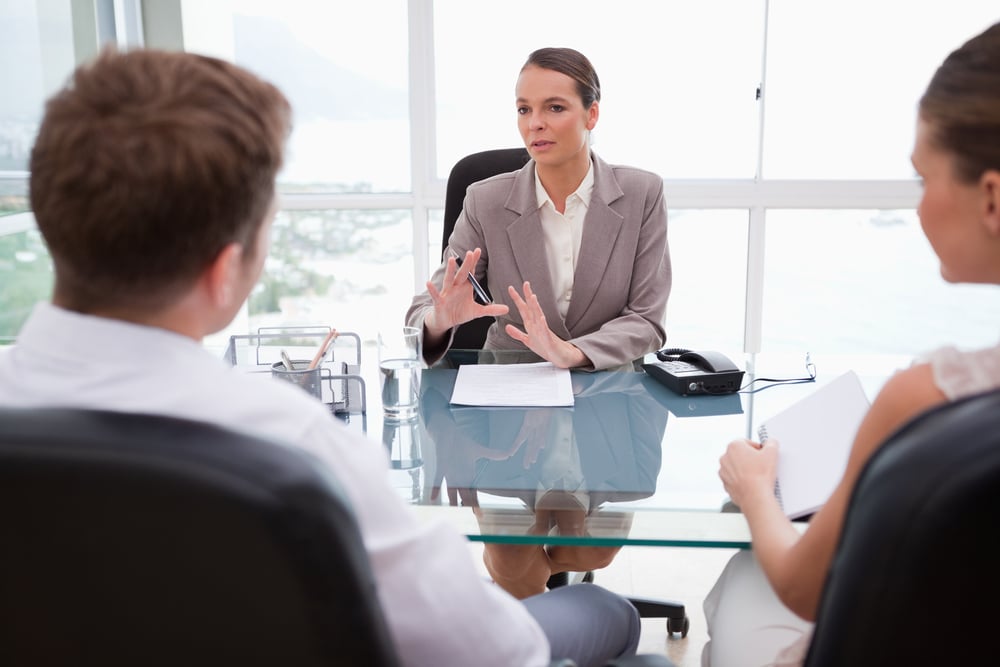 Lawyer explaining legal situation to her clients