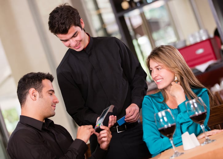 Man paying by credit card at a restaurant