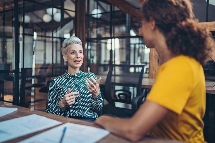 Manager in an open communication with employee symbolizing an open door policy at work