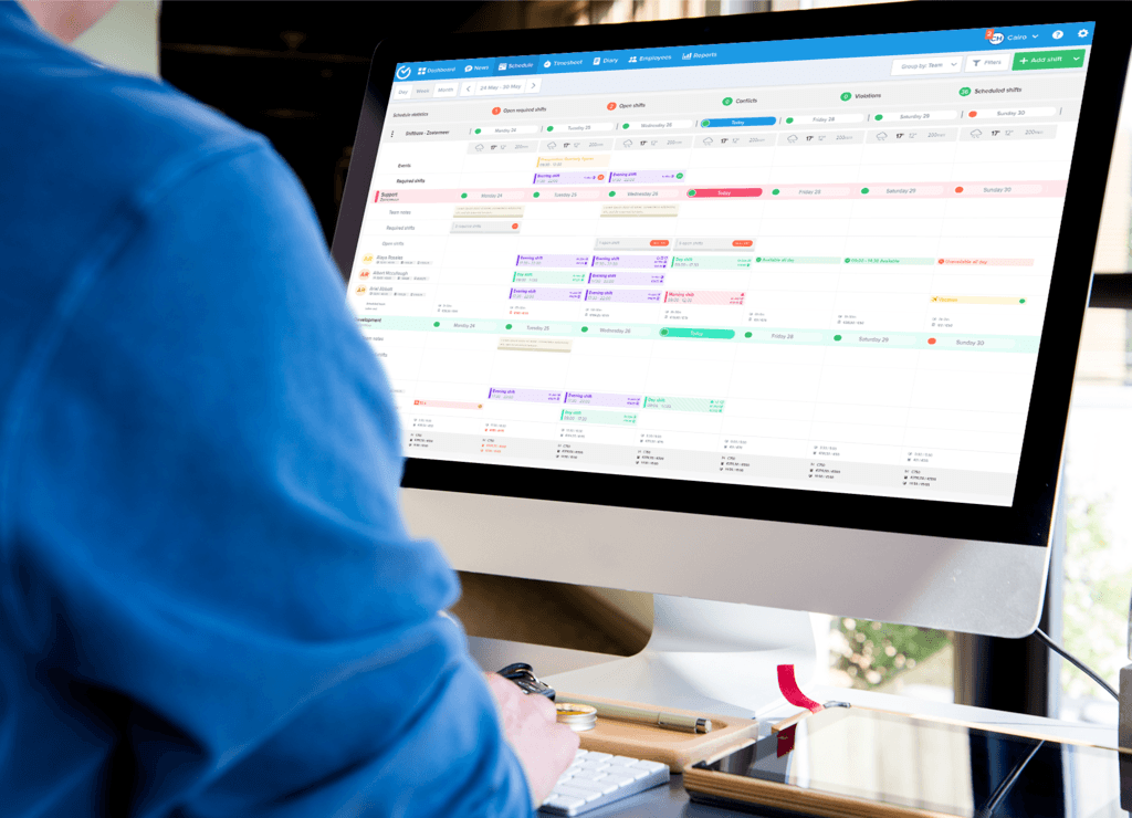 Manager working on Shiftbase scheduling tool to create employee schedules