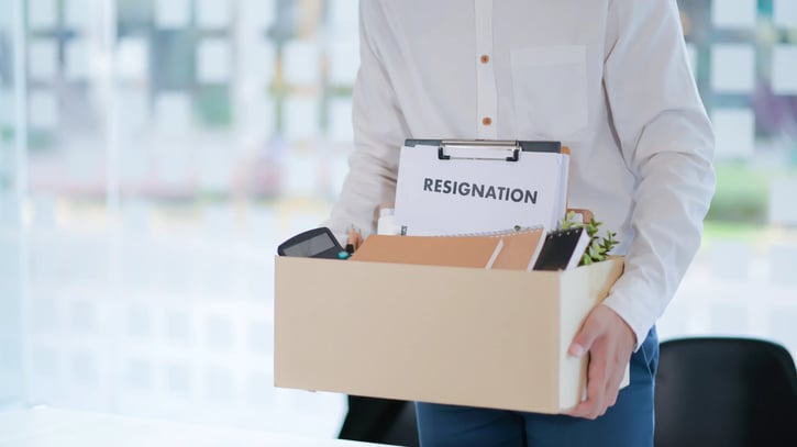 Office worker packing things after resigning from work