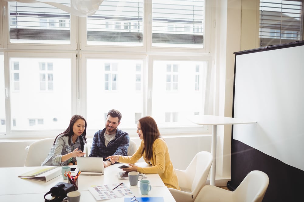 Photo editors using laptop in meeting room at office