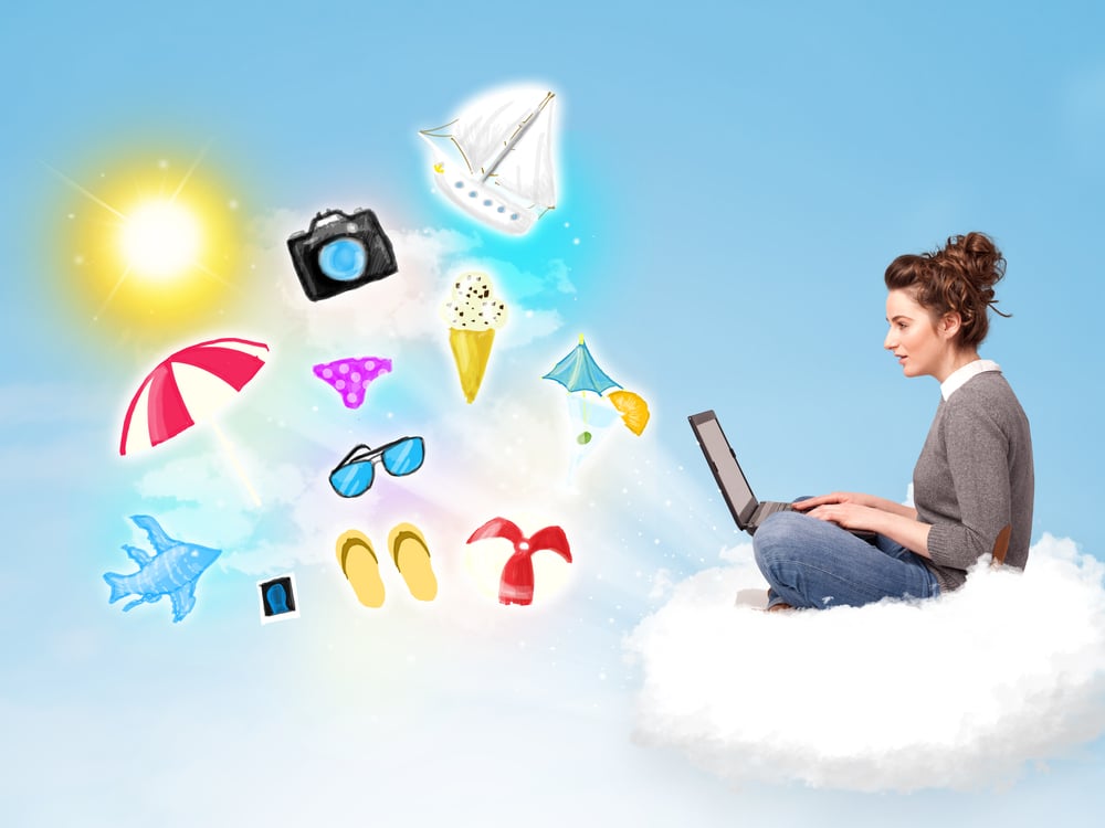 Pretty young woman sitting in cloud with laptop, summer travel concept