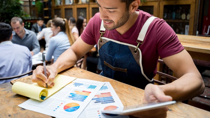 restaurant manager working on admin and overtime