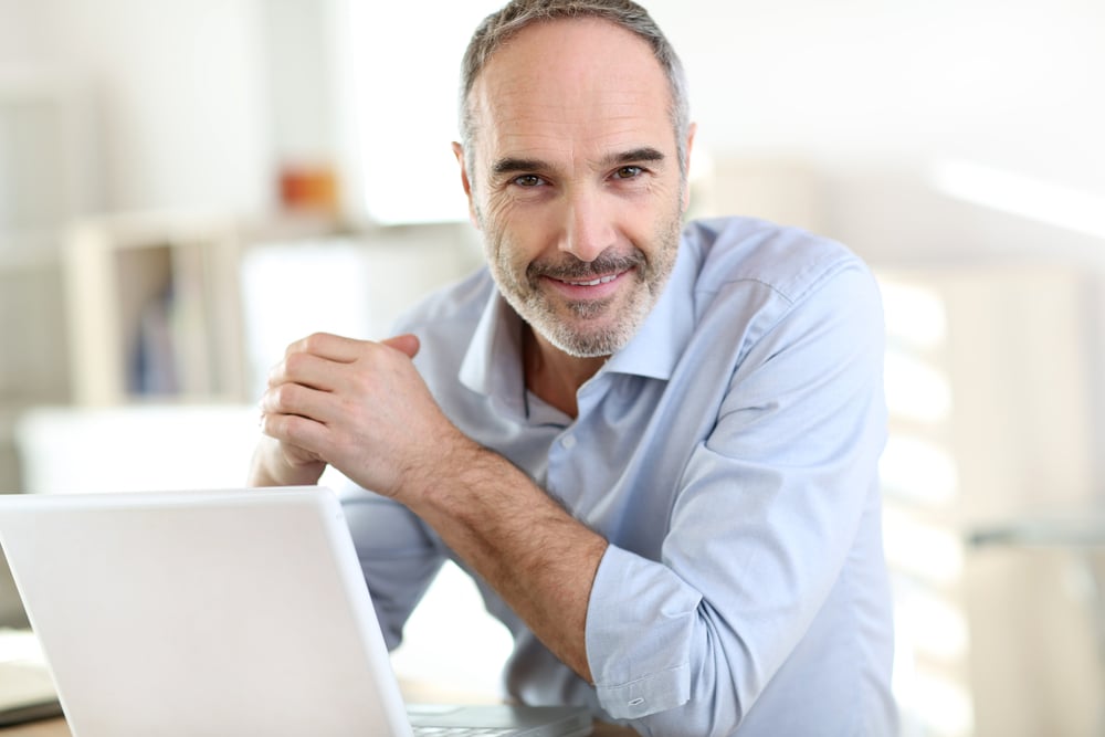 Senior businessman working on laptop computer