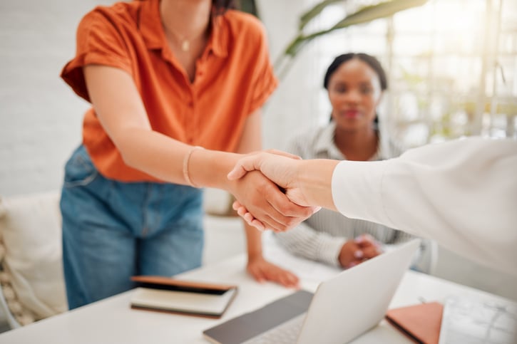 Shaking hands with new employee and starting the employee onboarding process