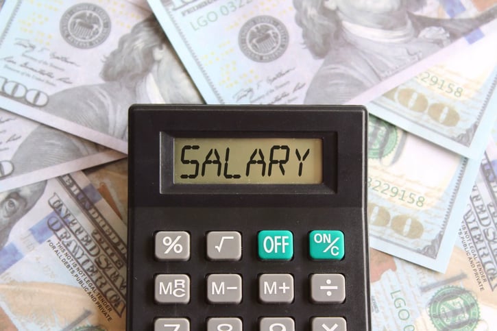 Top view image of calculator with text SALARY and money