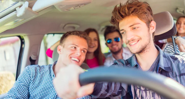 People smiling in a car