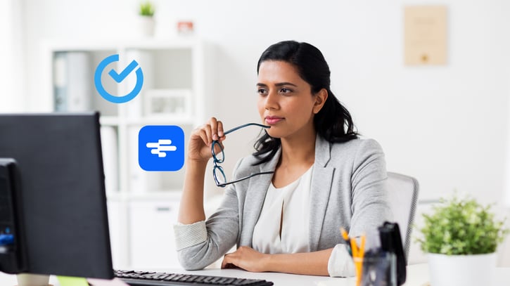 Woman looking at screen with Shiftbase and Rotacloud product logo's on top symbolising Shiftbase VS Rotacloud comparison