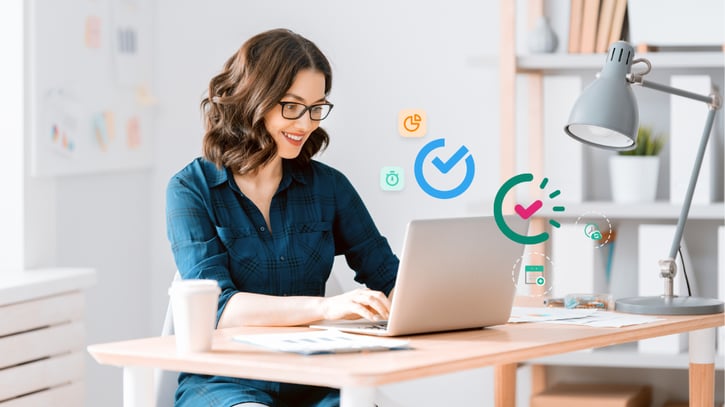 Woman using laptop with Shiftbase and Papershift product logo's on top symbolising Shiftbase VS Papershift comparison