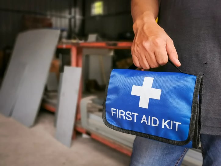 Worker holding first aid kit bag at the factory or workplace