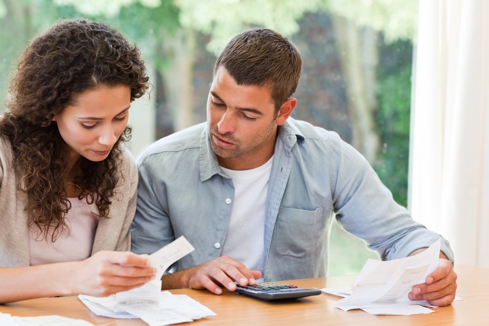 Young couple calculating their domestic bills at home-1