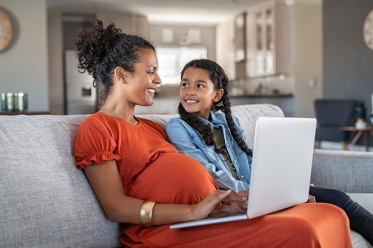 pregnant woman working from home on laptop symbolising KIT days