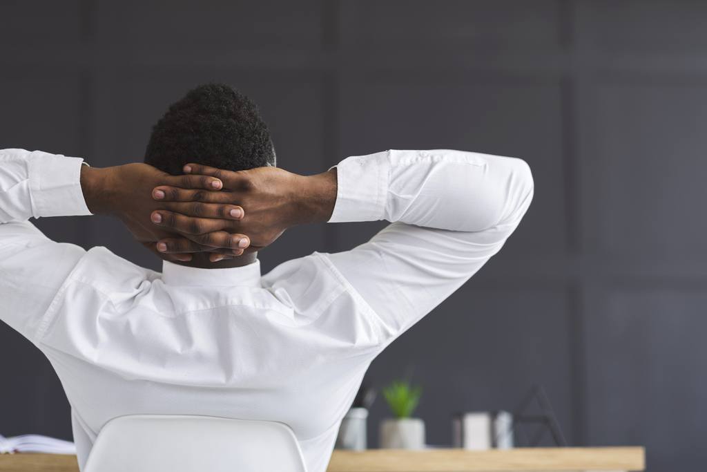 back view of employee relaxing in office