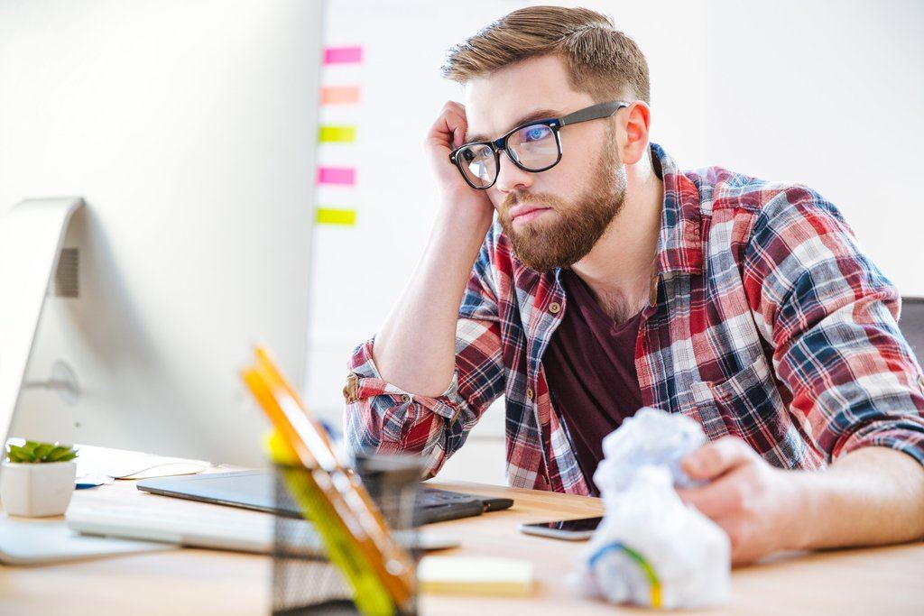 bored-exhausted-man-sitting-on-workplace-and-looki-2021-08-26-18-19-36-utc_50