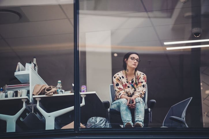 bored employee starring away in the office symbolising resenteeism