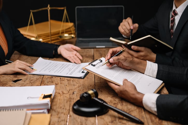 business executives going over contract to hire documents