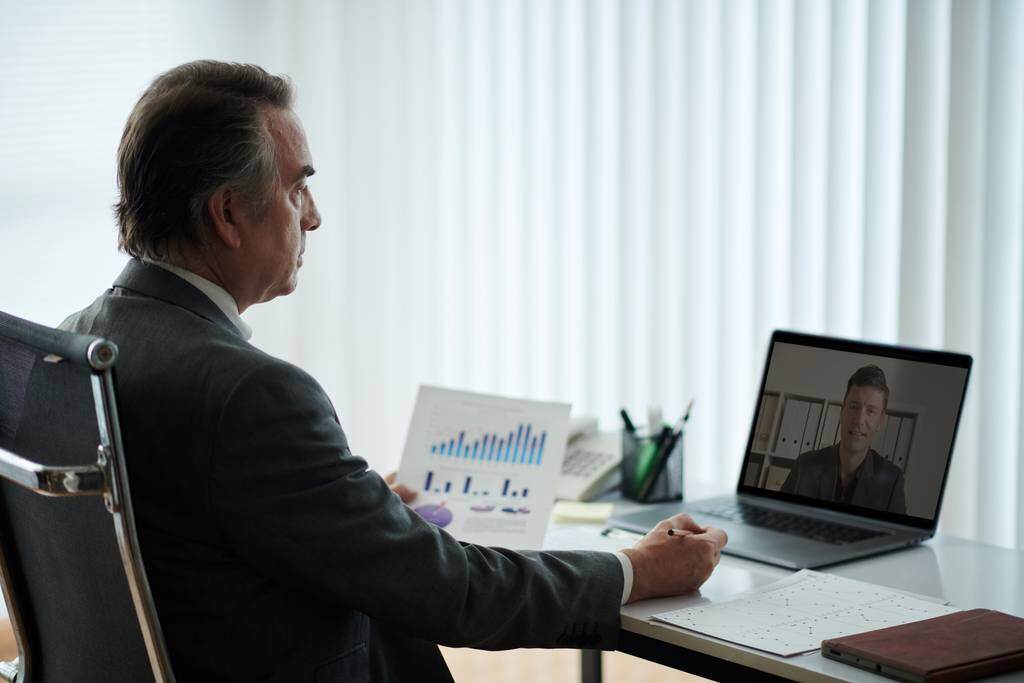 business man having a meeting with remote employee