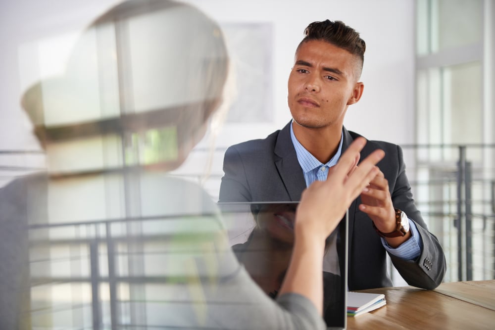 business people having a meeting in executive sunlit office