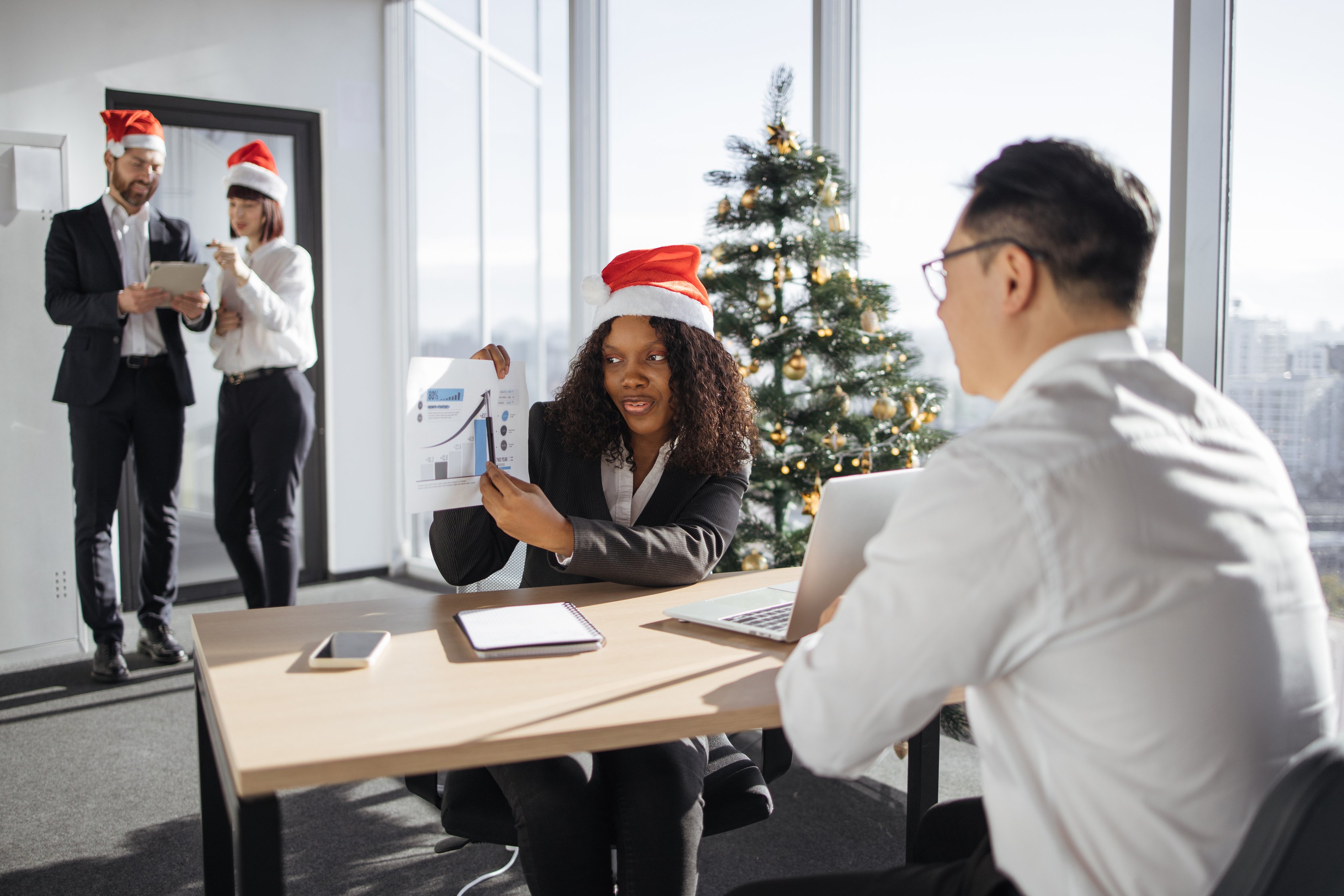 business woman sharing results of Christmas bonus impact