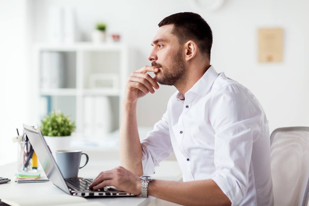 businessman-with-laptop-thinking-at-office-2022-12-16-09-45-46-utc_50