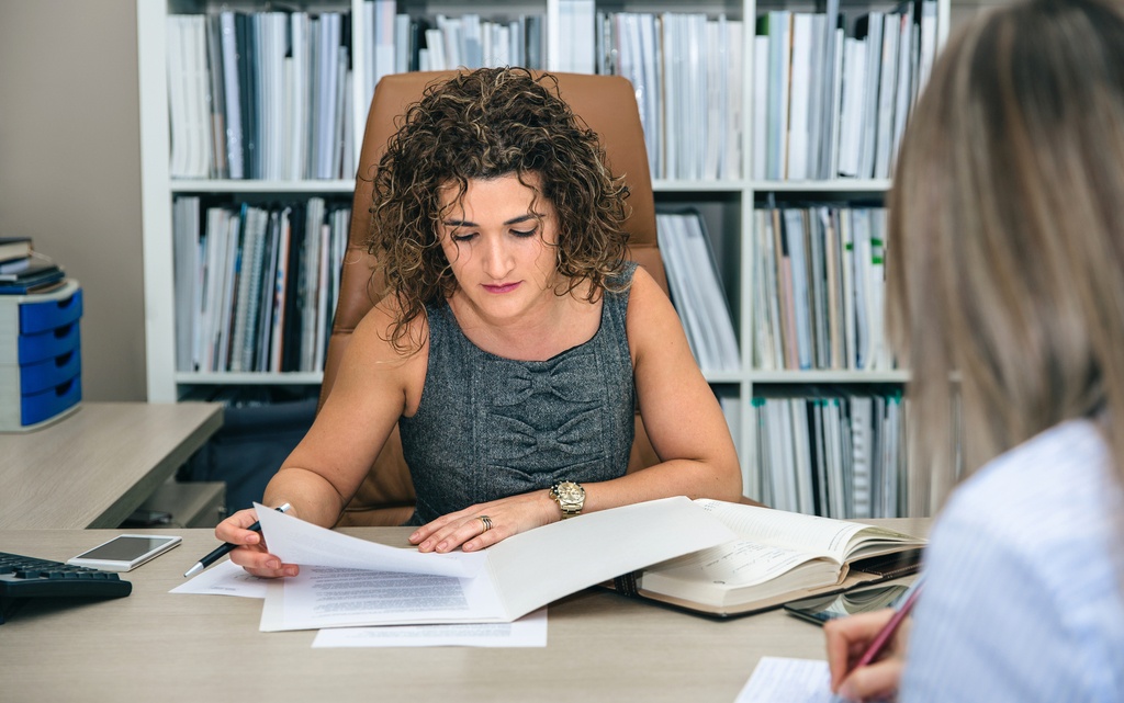 businesswomen working in office looking over documents