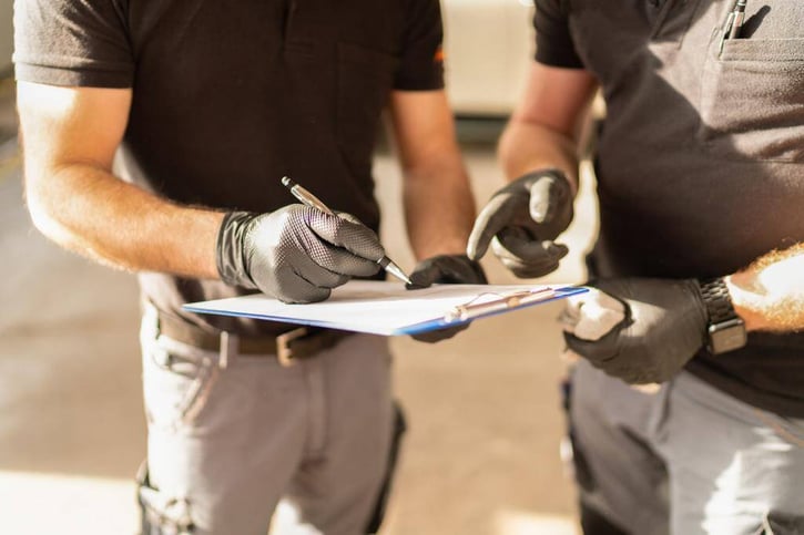 field manager noting down lost time incident rate on paper