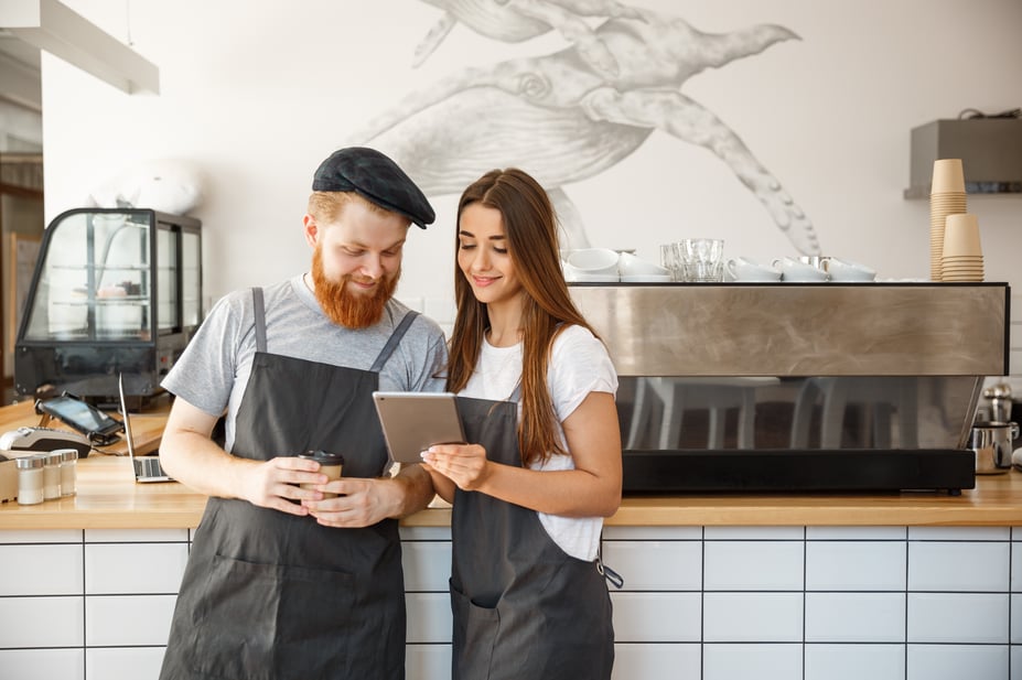 coffee shop manager baristas look at tablet, how to run a cafe